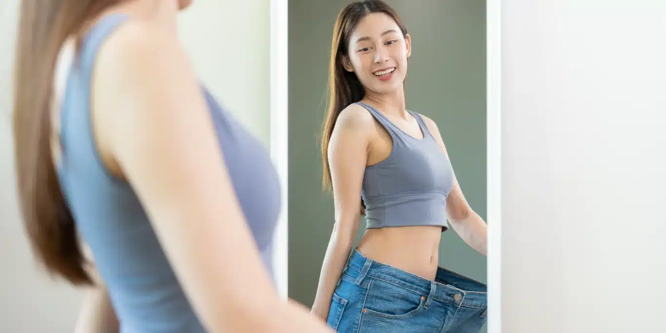 beautiful girl hand show shape her weight loss